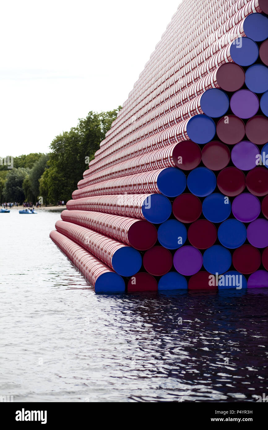 London, UK. 23 June 2018 The Mastaba, a temporary sculpture made of stacked barrels in Serpentine Lake in Hyde Park, is made by one of the world's most celebrated artists, famous for ambitious large scale works. Christo and his late wife Jean-Claude took an inspiration from ancient mastabas (benches) structures that originated in first urban civilisatons of Mesopotamia. Twenty metres in height, the structure consists of 7506 horizontally-stacked coloured barrels. The sculpture coincides with Serpentine Galleries exhibition of Christo and Jeanne-Claude's use of barrels in their work over th Cre Stock Photo