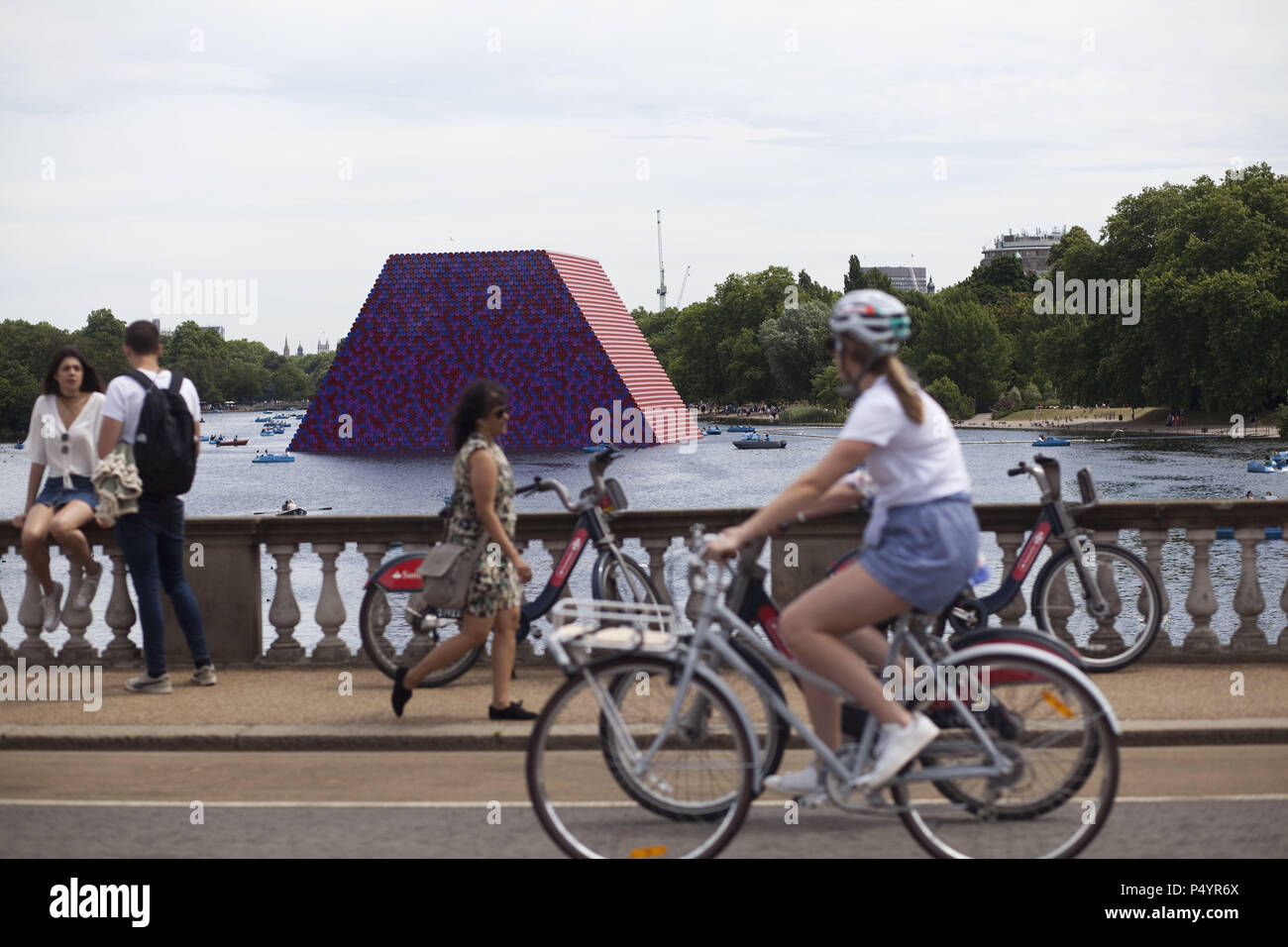 London, UK. 23 June 2018 The Mastaba, a temporary sculpture made of stacked barrels in Serpentine Lake in Hyde Park, is made by one of the world's most celebrated artists, famous for ambitious large scale works. Christo and his late wife Jean-Claude took an inspiration from ancient mastabas (benches) structures that originated in first urban civilisatons of Mesopotamia. Twenty metres in height, the structure consists of 7506 horizontally-stacked coloured barrels. The sculpture coincides with Serpentine Galleries exhibition of Christo and Jeanne-Claude's use of barrels in their work over th Cre Stock Photo