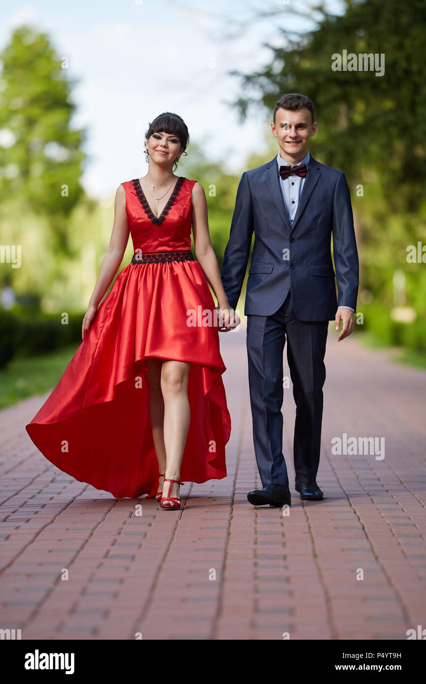 Elegant young couple having a walk in the park Stock Photo - Alamy