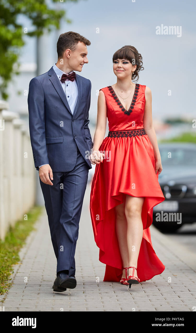 Elegant young couple having a walk in the park Stock Photo - Alamy