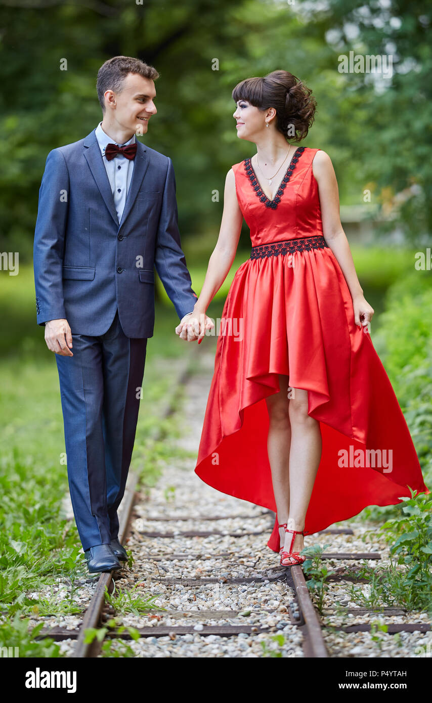 Elegant young couple having a walk in the park Stock Photo - Alamy