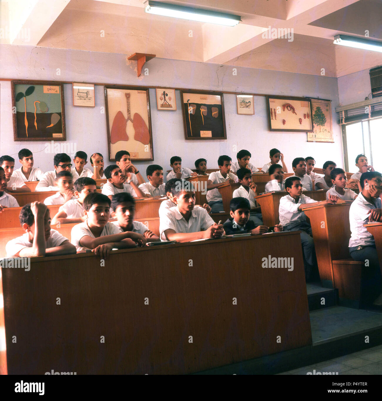 Jeddah, Saudi Arabia, mid-1960s, picture of a class of boys at the Al-Thager secondary school. Faisal bin Abdul Aziz - the King of saudi Arabia from 1964 to 1975- founded the school in Taif in the early 1950s and subsquently opened a large campus in Jeddah. The 'model' school became the most prestigious in the city with children of the Royal family attending. One can see that the boys wear 'western-style' school uniforms rather that Arabian clothing of thobes and headresses. The English language was widely taught. Osama bin Laden attended Al-Thager from 1968-1976. Stock Photo