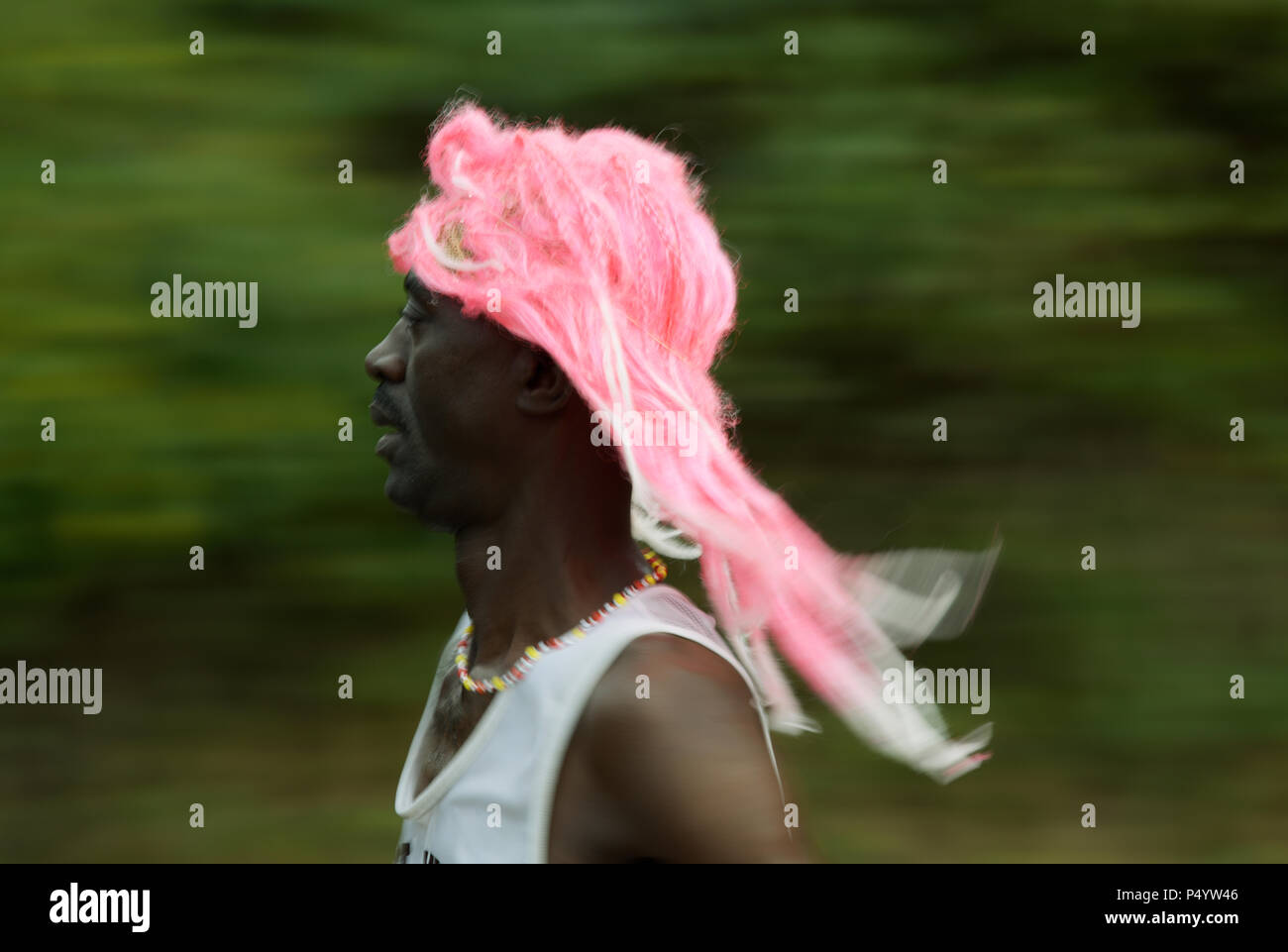 Durban, KwaZulu-Natal, South Africa, single adult man runner wearing colourful pink flowing hairpiece, 2018 Comrades Marathon, Valley of 1000 hills Stock Photo