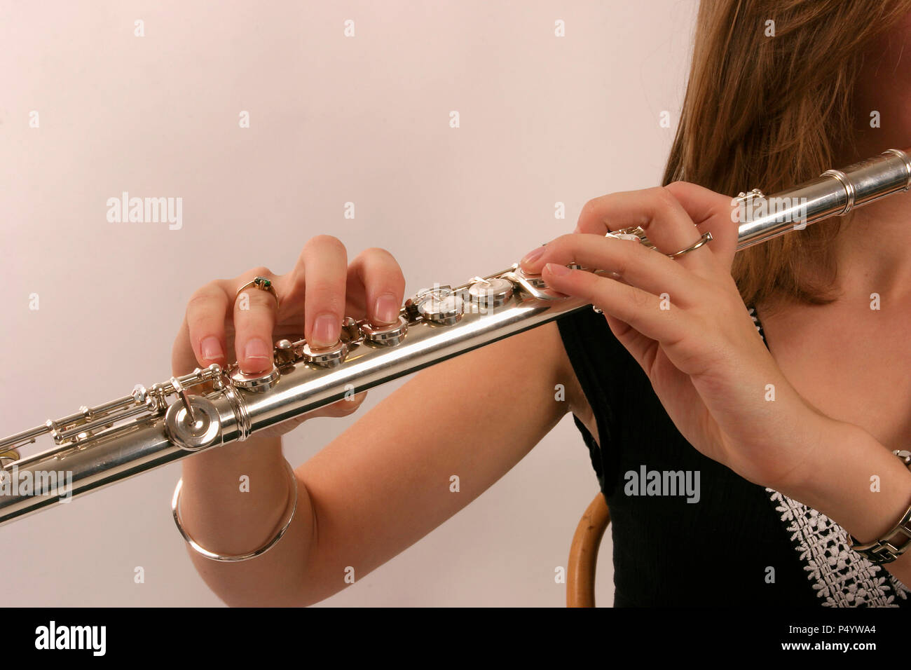 Flute in playing position, showing fingers on keys Stock Photo Alamy
