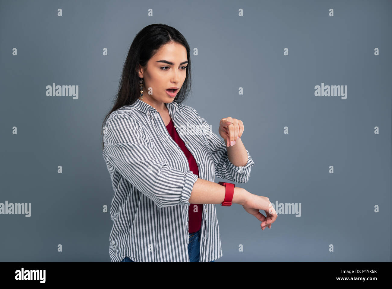 Pleasant young woman learning she being late Stock Photo