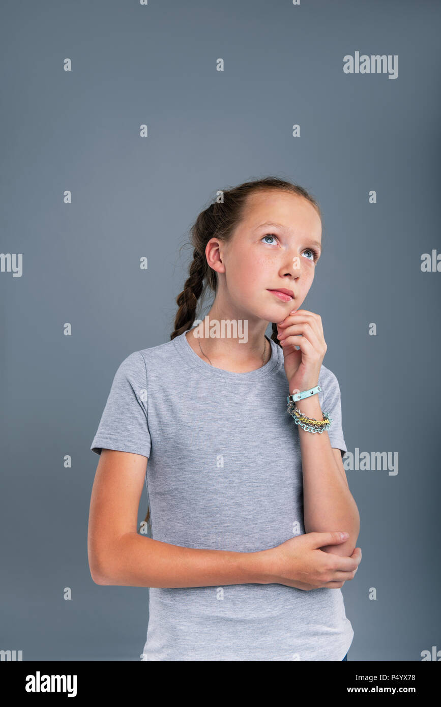 Pleasant teenage girl being deep in thought Stock Photo Alamy