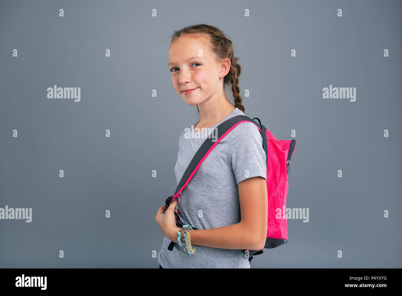 Cute teenage girl posing while wearing a backpack Stock Photo - Alamy