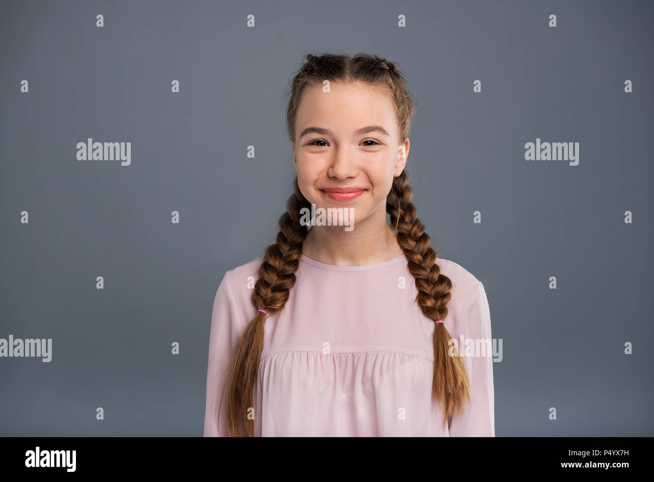 Portrait Of A Cute Teenage Girl With Two Braids Stock Photo