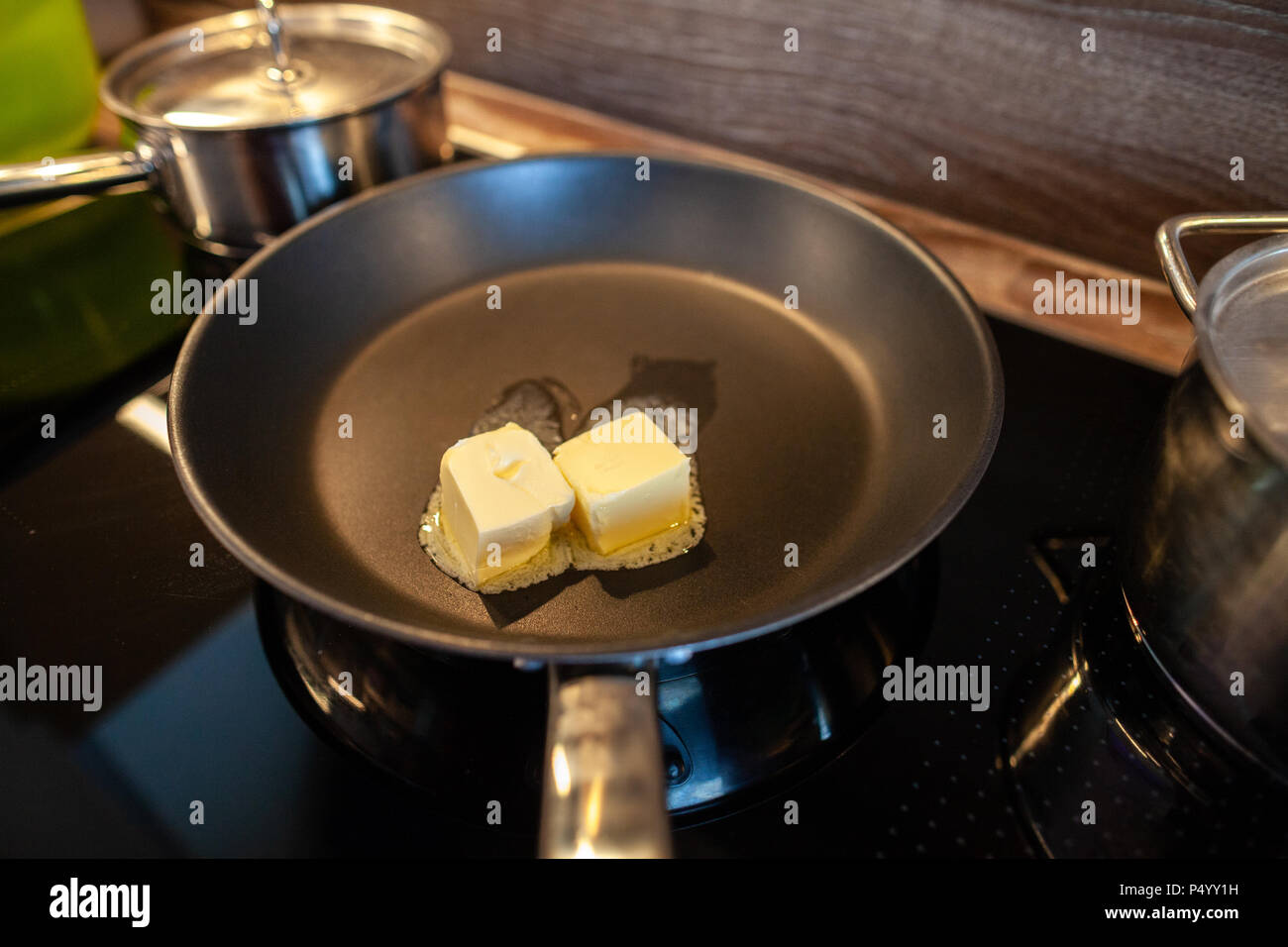 melting butter in a pan on a hot plate Stock Photo Alamy