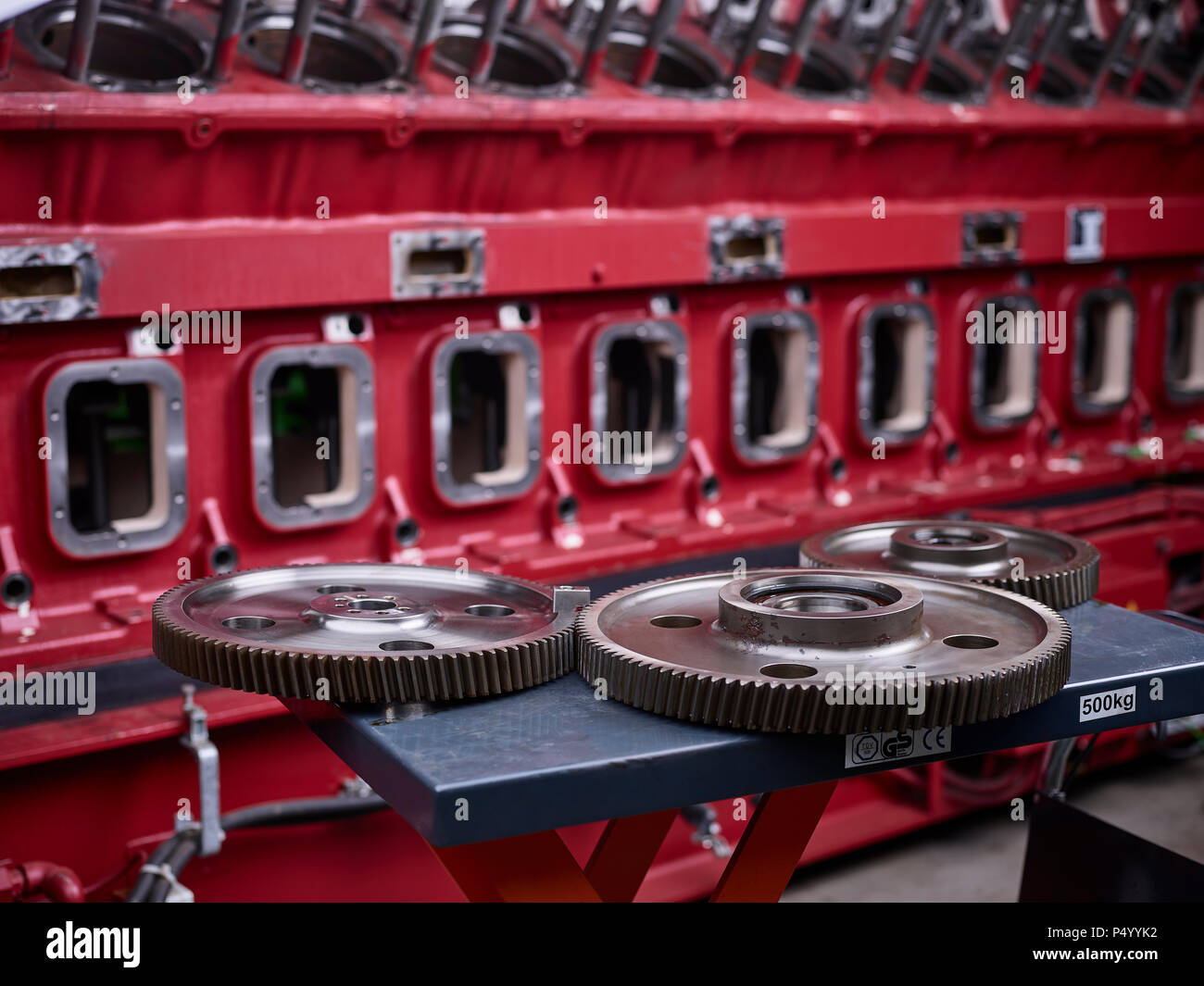 Cogwheels in front of engine block Stock Photo