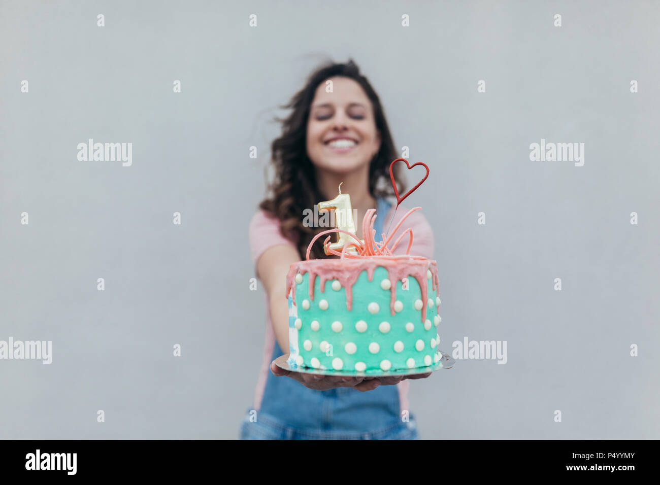 Woman presenting Birthday cake Stock Photo