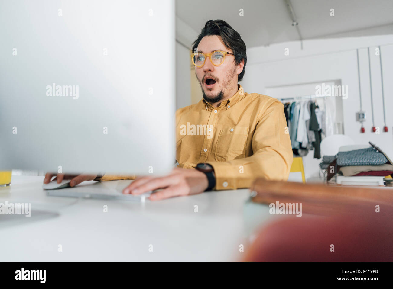 Portrait of scared freelancer working  on computer Stock Photo