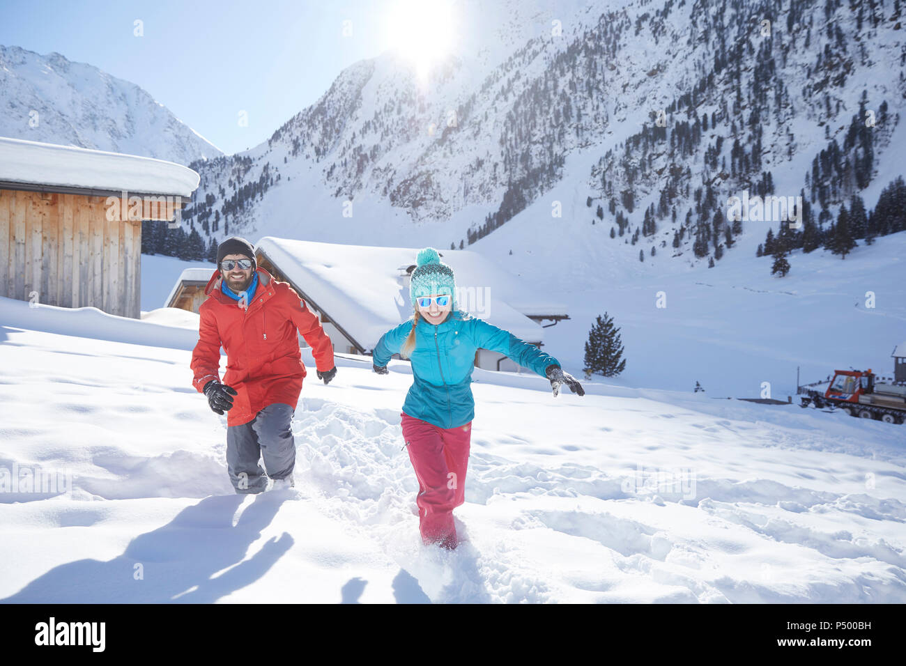 Active couple having fun in snow-covered landscape Stock Photo