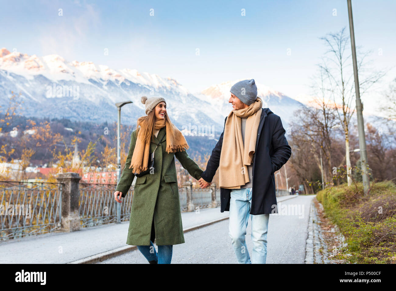 Austria, Innsbruck, happy young couple strolling together hand in hand at winter time Stock Photo