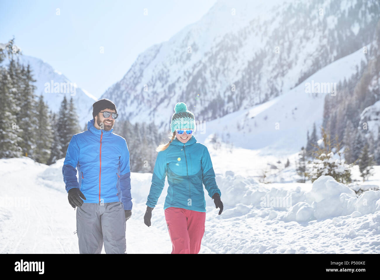 Couple walking in snowcovered landscape Stock Photo Alamy