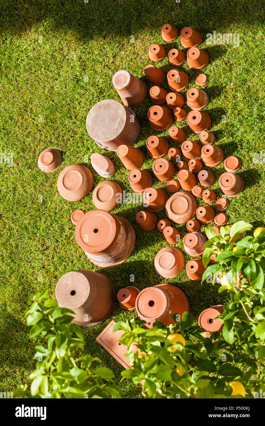 Empty flower pots standing upside down on grass Stock Photo