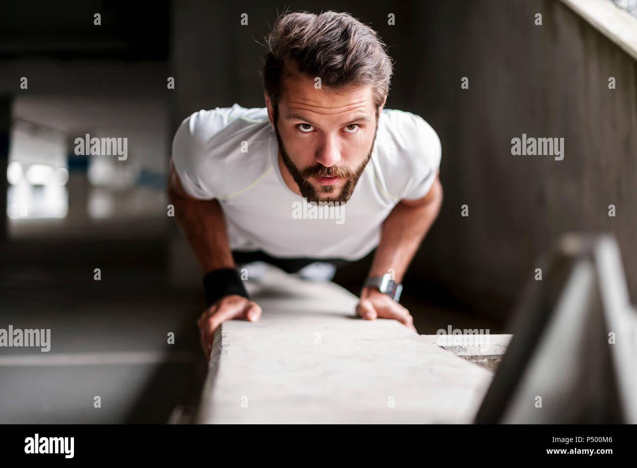 Portrait of man doing push-ups Stock Photo
