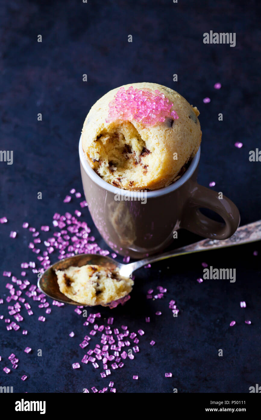 Vanilla cup cake with chocolate and pink sugar granules Stock Photo
