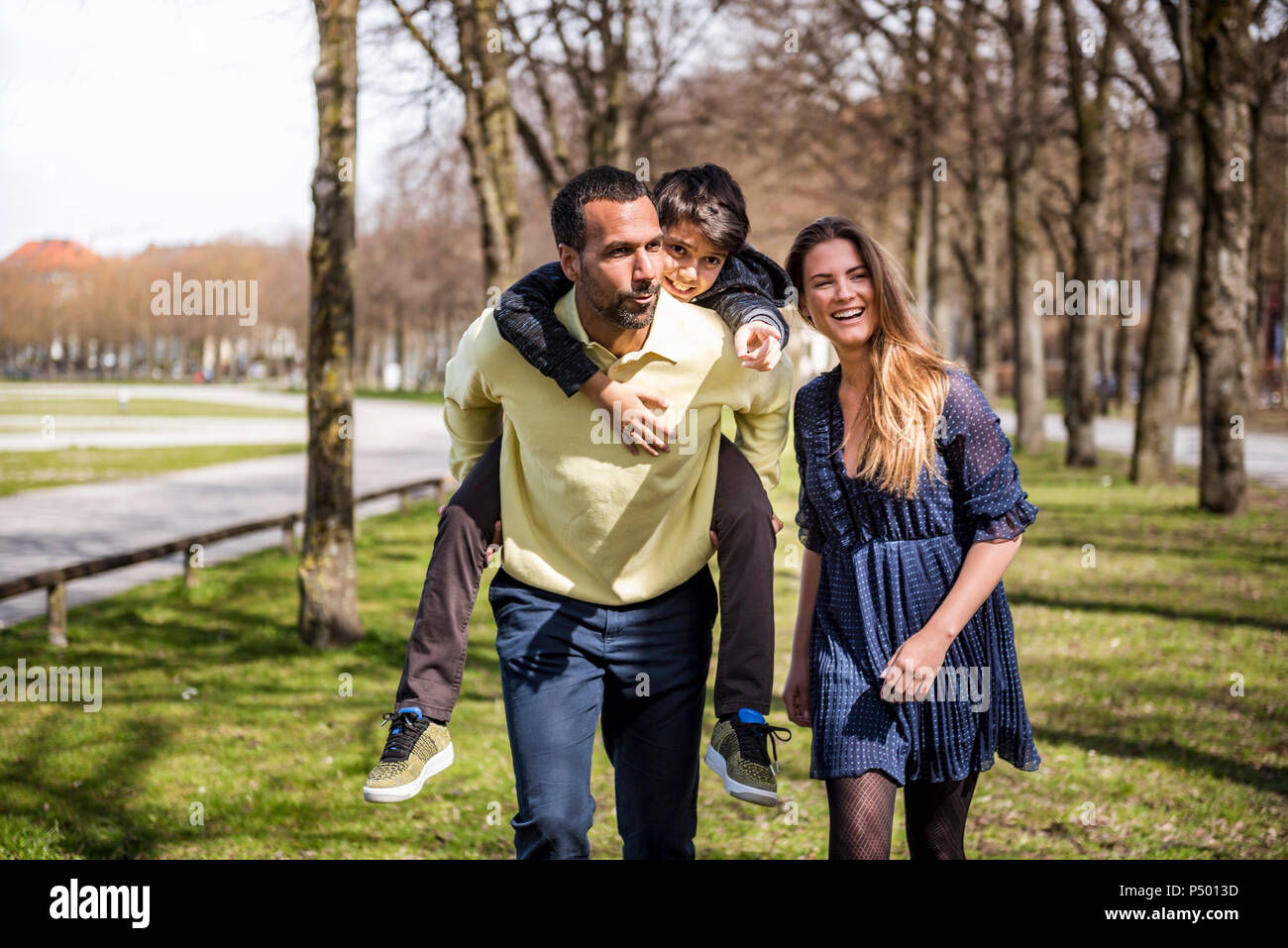 Happy family walking in a park Stock Photo - Alamy
