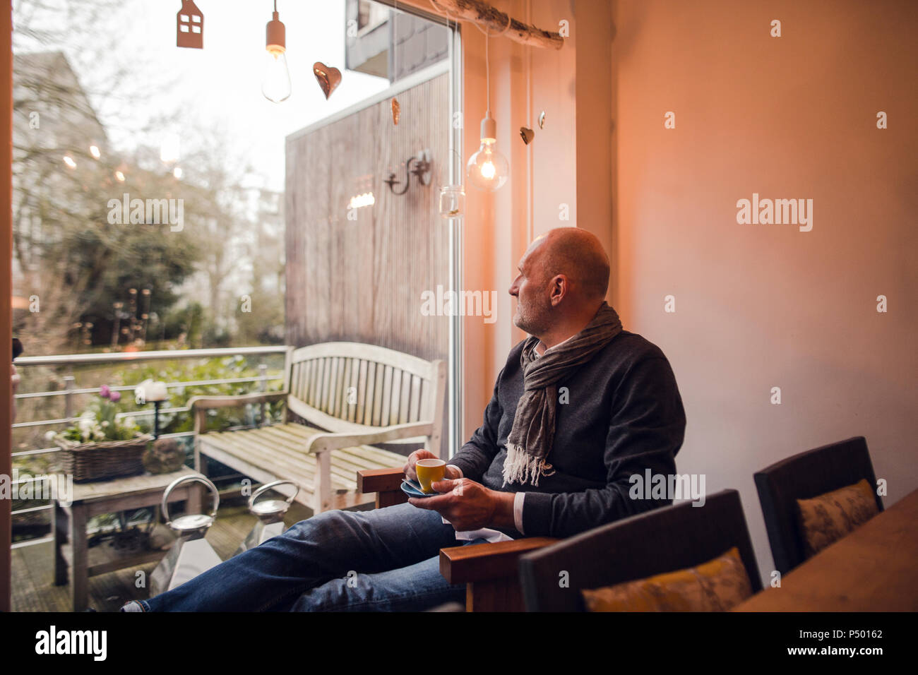 Senior man sitting at home, drinking coffee Stock Photo