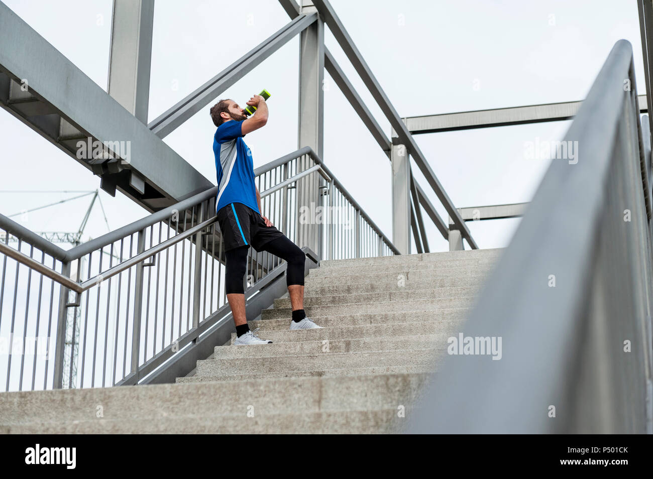 Man on stairs having a break from running Stock Photo