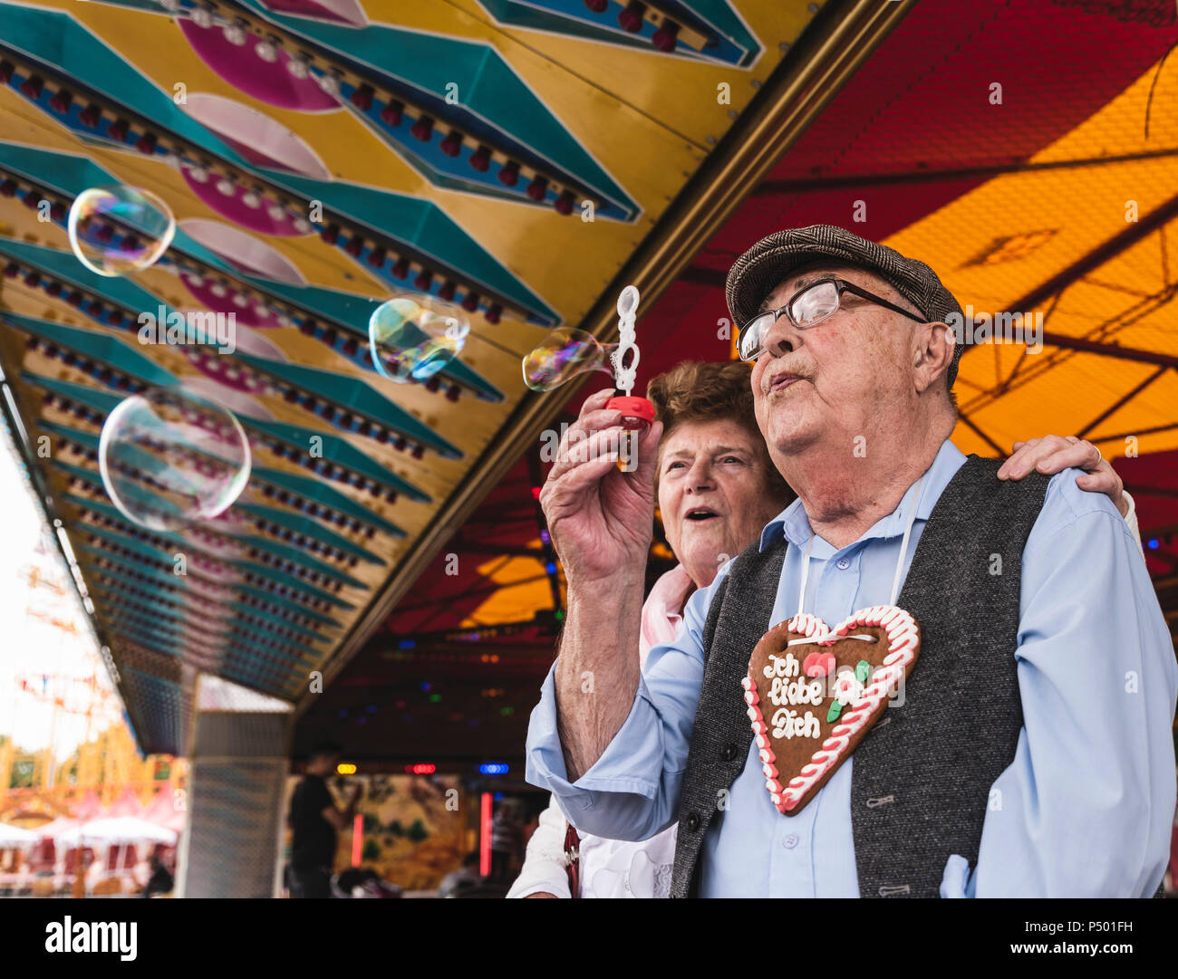 Senior couple having fun together on fair Stock Photo