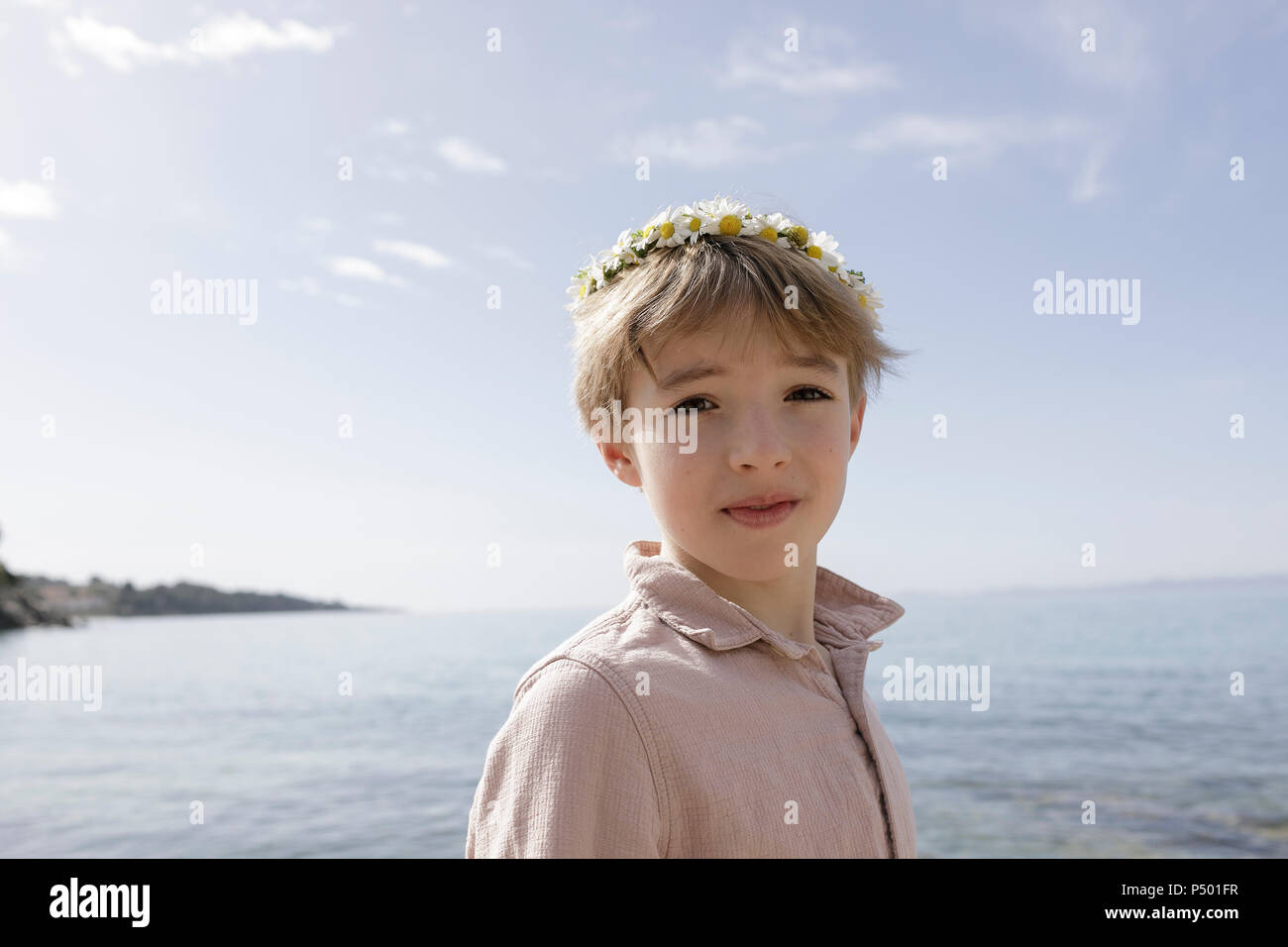 Portrait of boy wearing flowers Stock Photo