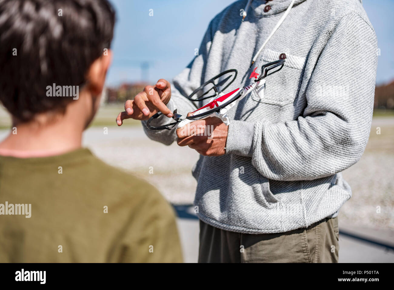 Father and son flying drone Stock Photo