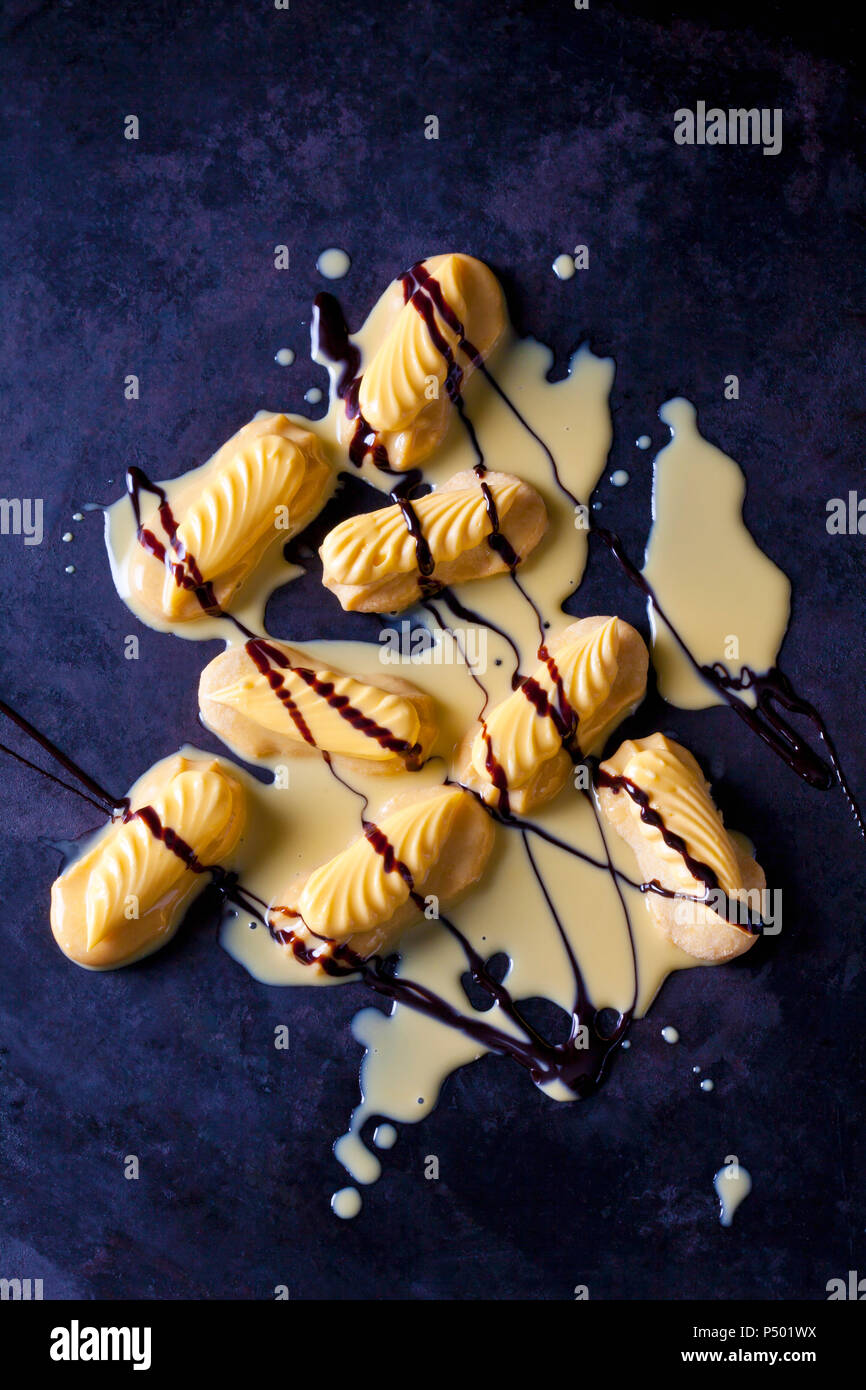 Shortcrust pastry with egg liquer and chocolate sauce on dark ground Stock Photo
