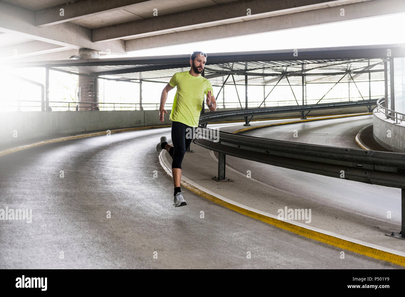 Man running in parking garage in a curve Stock Photo Alamy