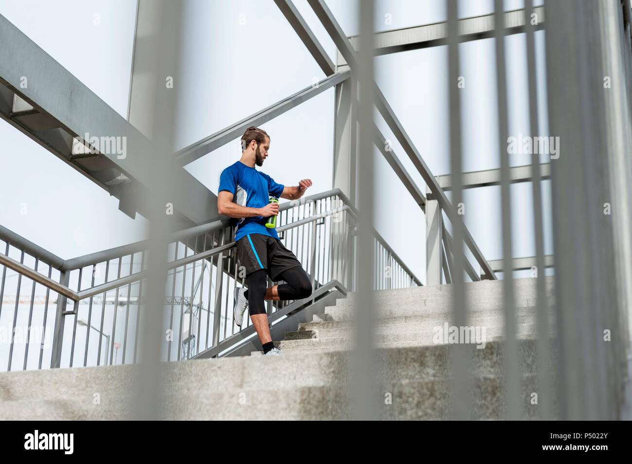 Man on stairs having a break from running Stock Photo