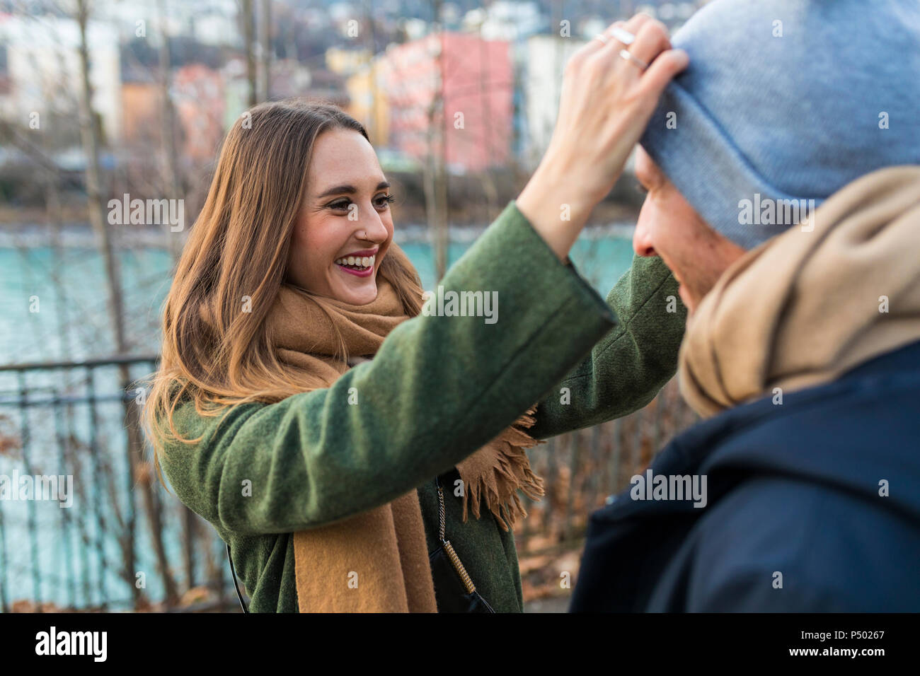 Portrait of happy young woman having fun with her boyfriend at winter time Stock Photo