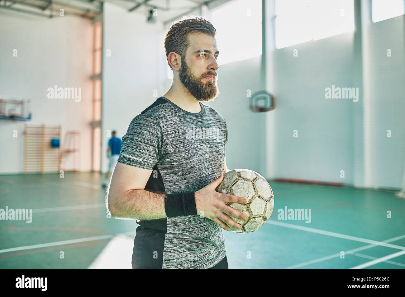 Portrait of indoor soccer player holding the ball Stock Photo