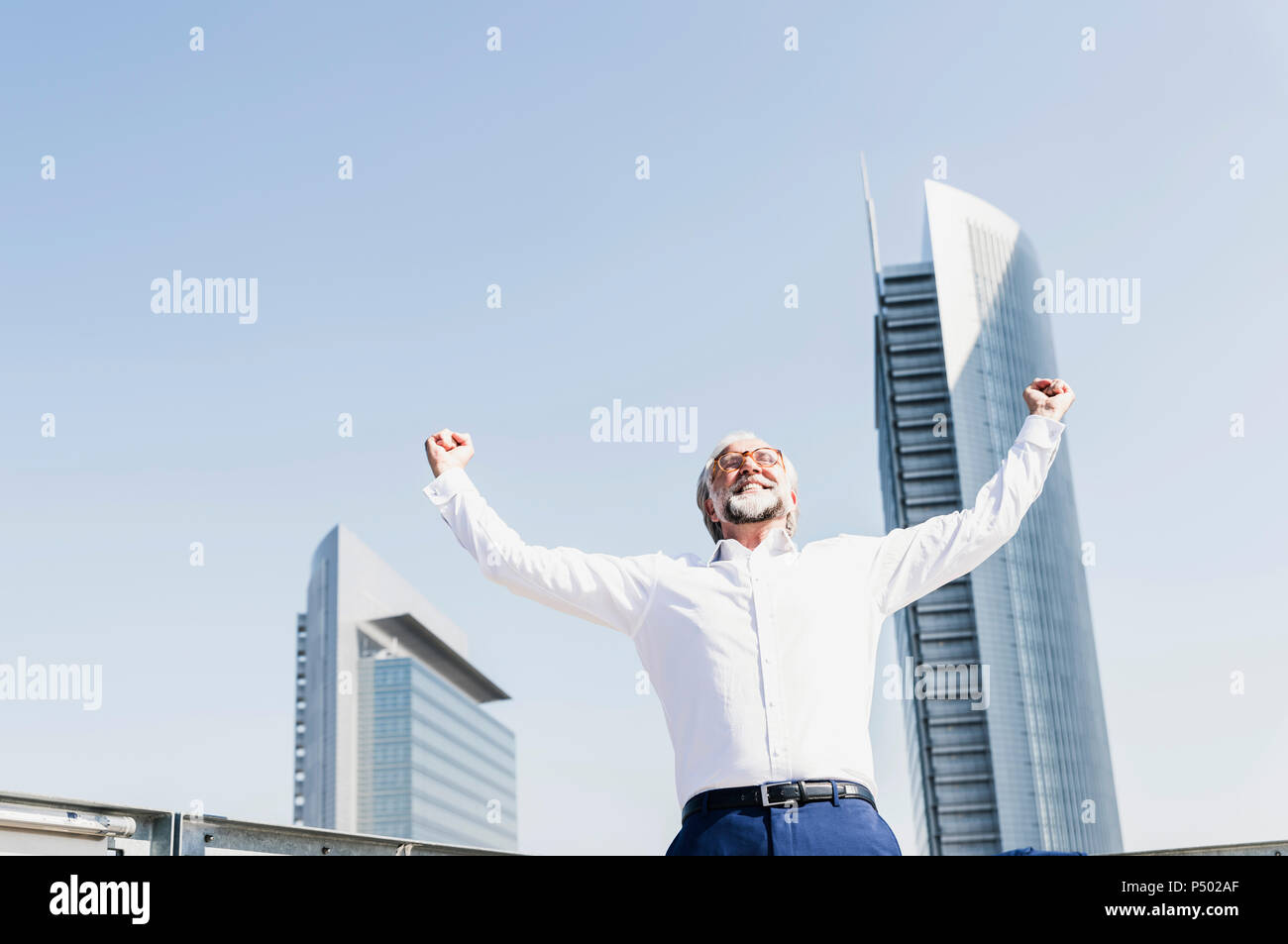 Happy mature businessman cheering in the city Stock Photo - Alamy