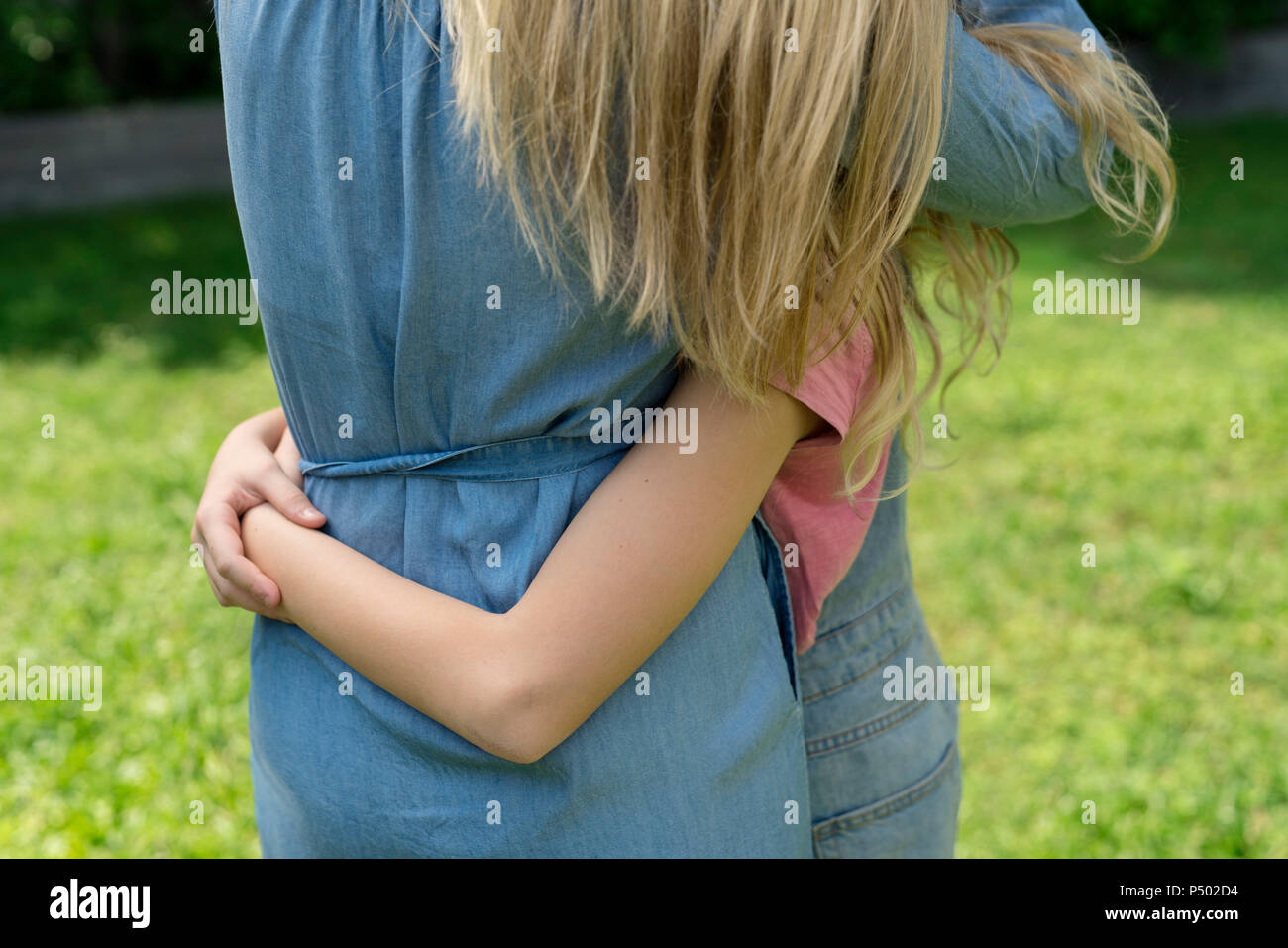 Mother and daughter hugging each other Stock Photo