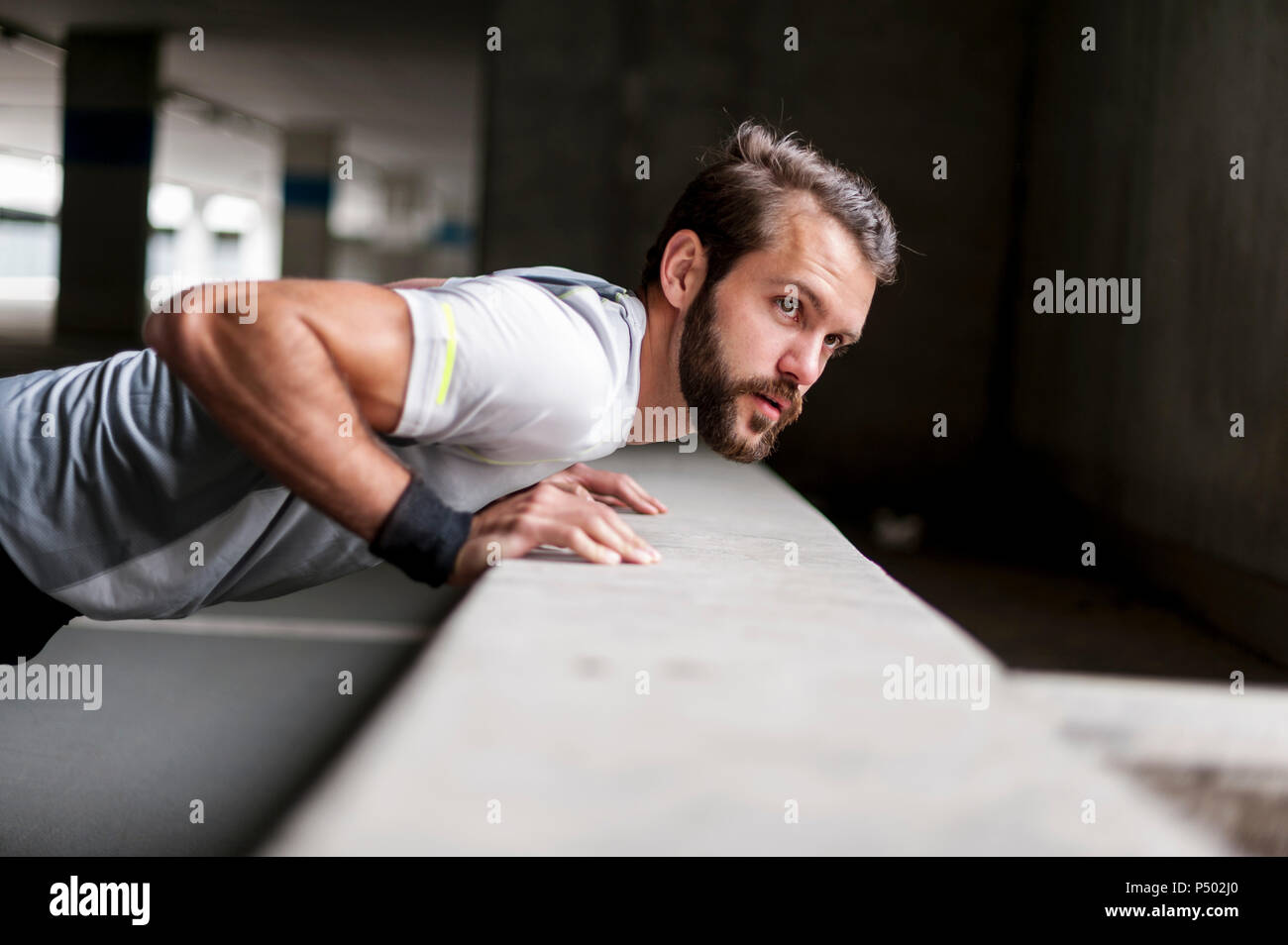 Portrait of man doing push-ups Stock Photo