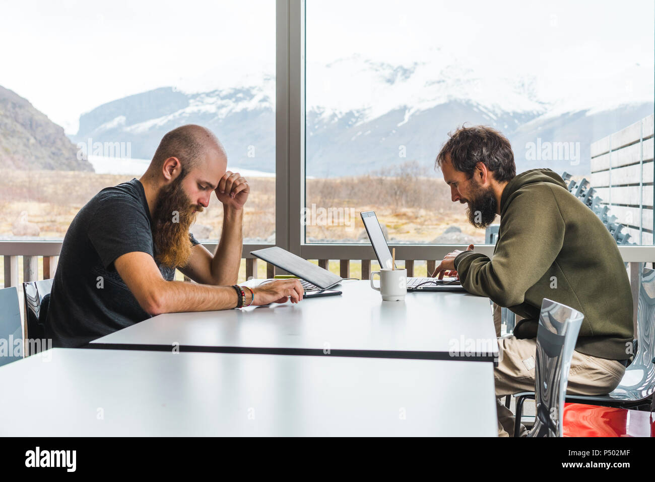 Island, two Hipsters sitting at table in a coffee shop Stock Photo