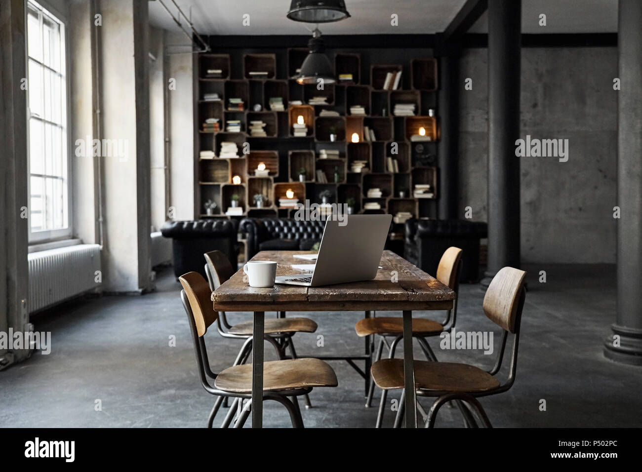 Laptop on table in loft Stock Photo