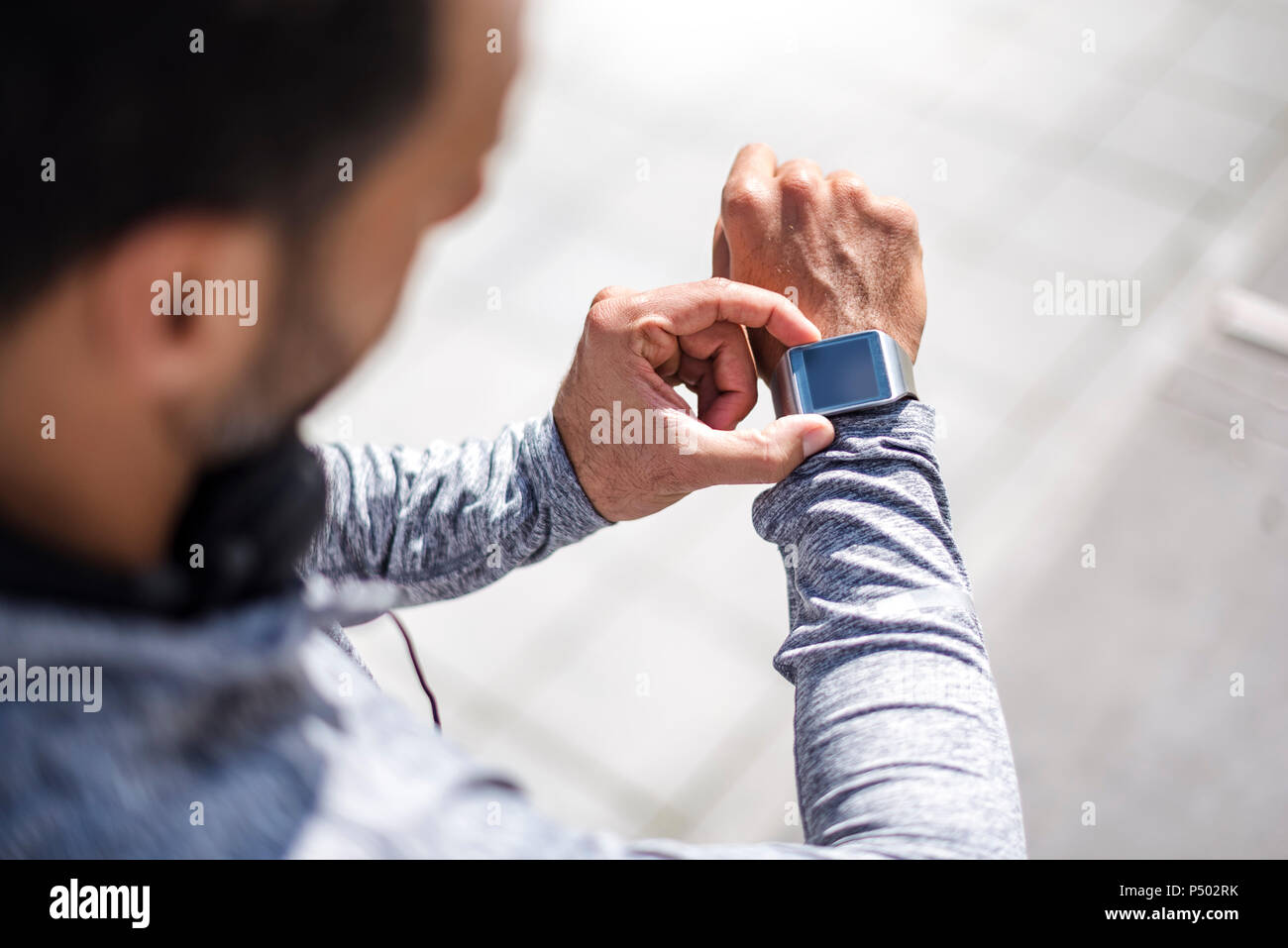 Close-up of athlete checking smartwatch Stock Photo