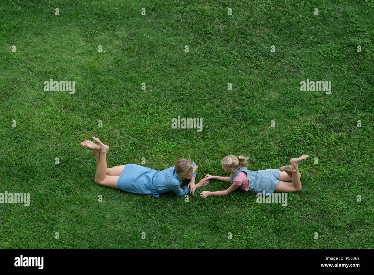 Bird's eye view of mother and daughter talking to each other in garden Stock Photo