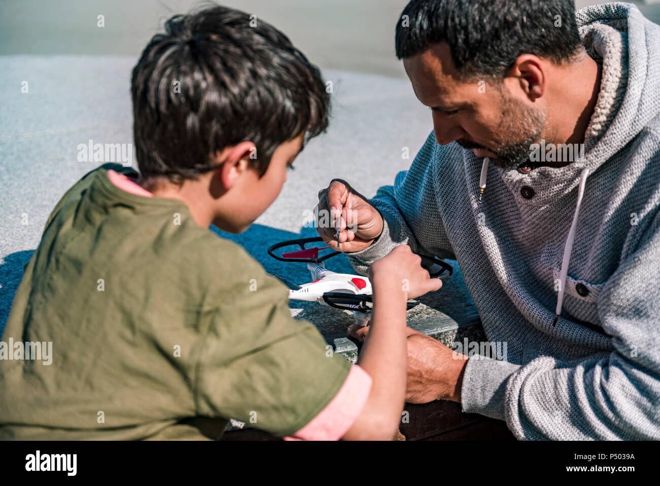 Father and son repairing drone Stock Photo - Alamy