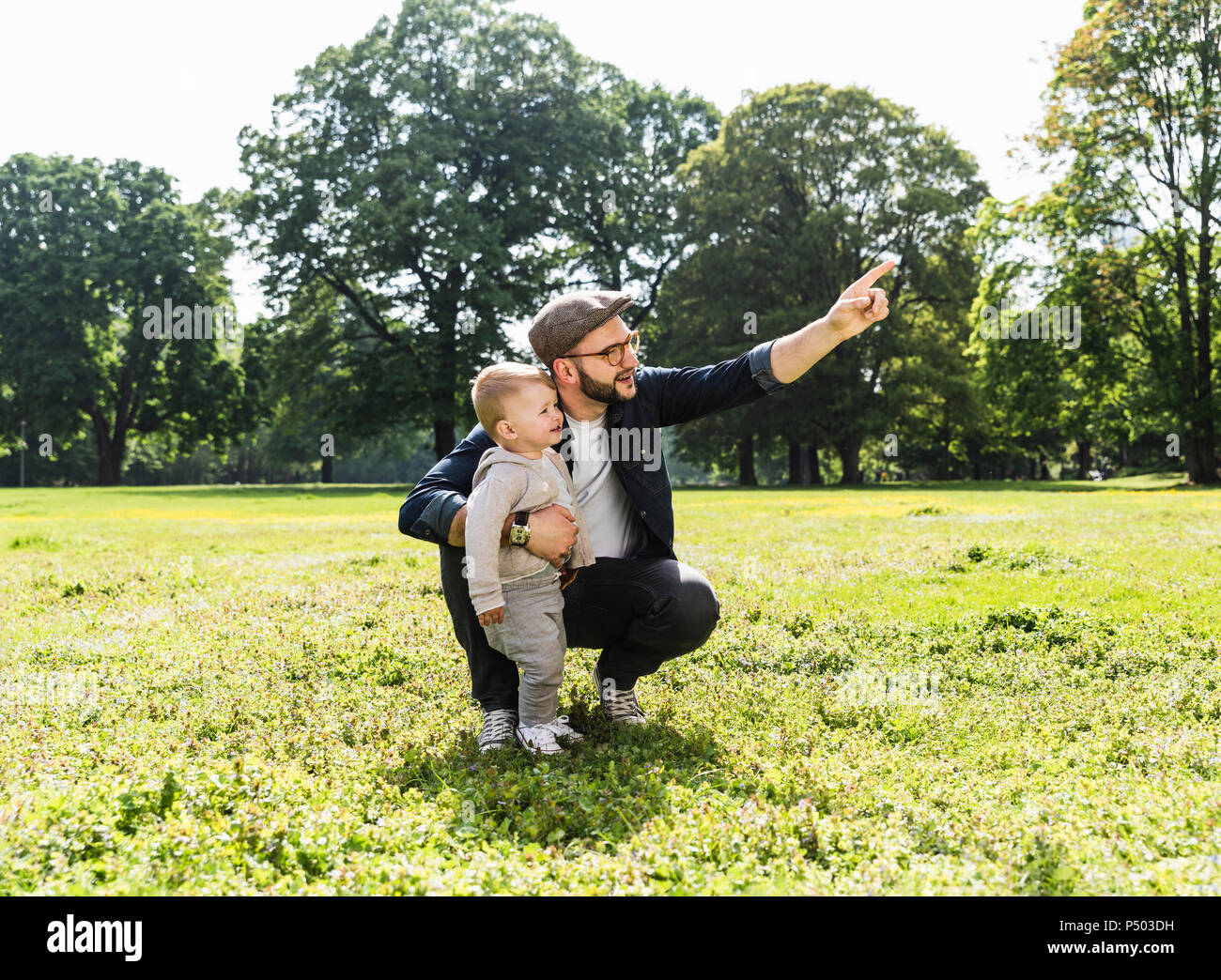Father talking to son in a park Stock Photo