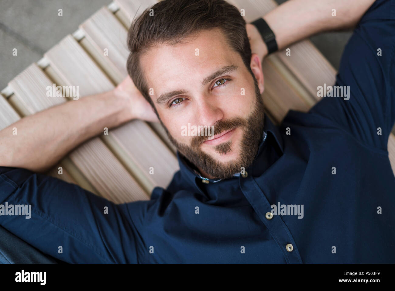 Portrait of bearded young man lying down Stock Photo