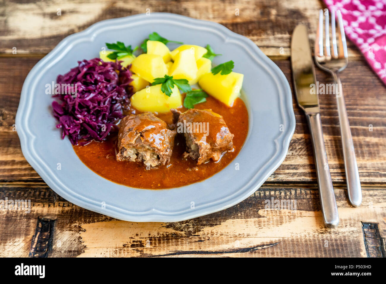 Beef roulade with potato and red cabbage on plate Stock Photo