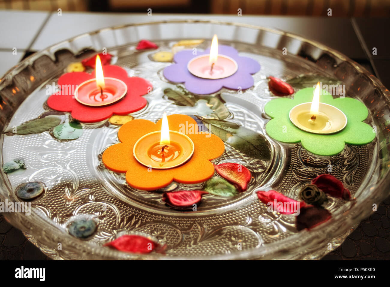 close up shot of floating candles in glass bowl Stock Photo Alamy