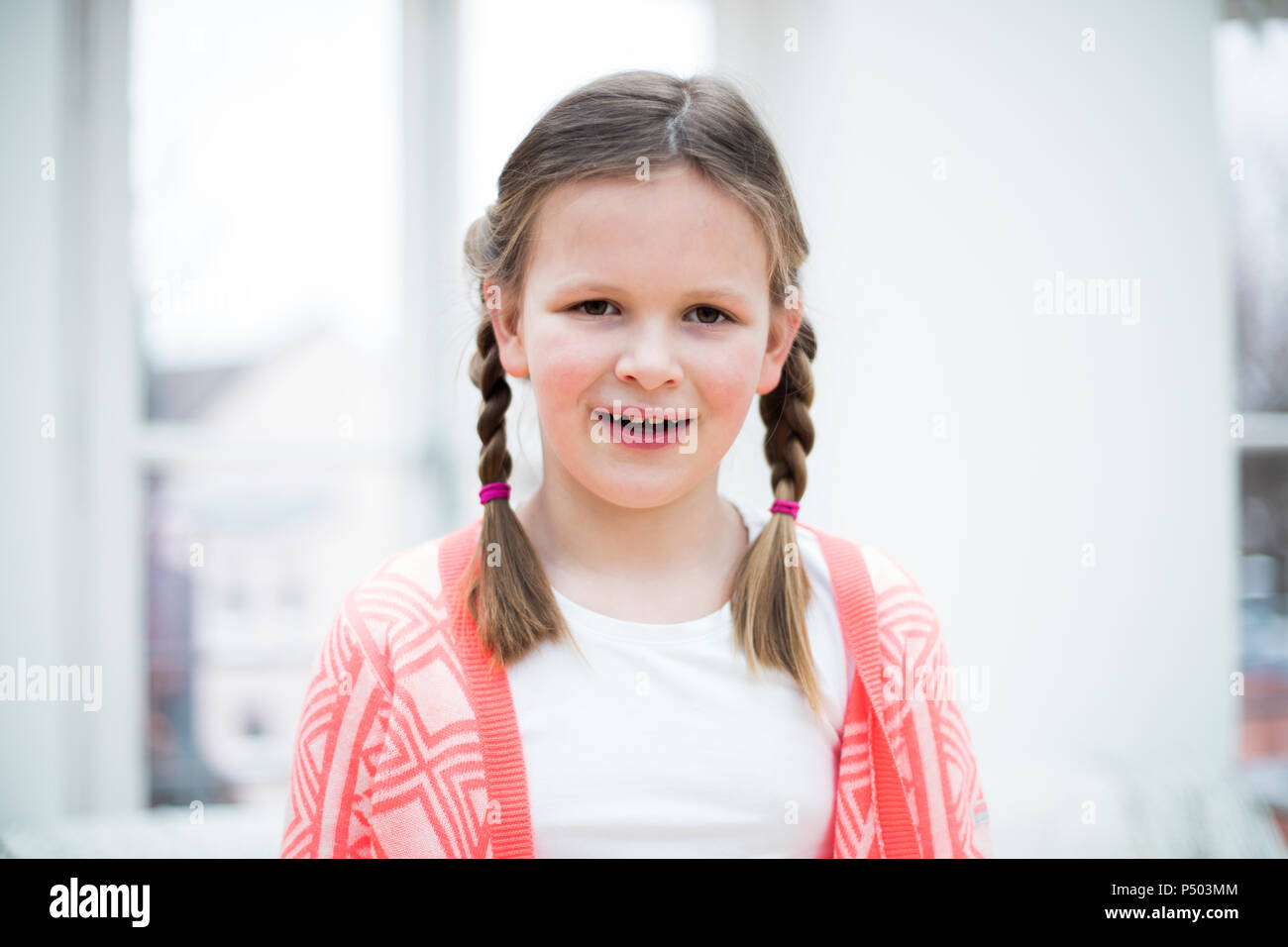 Portrait of smiling girl with braids Stock Photo