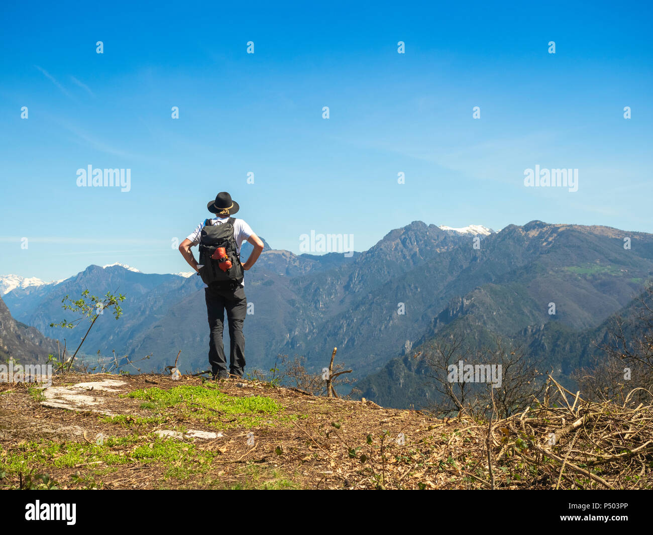 Italy, Lombardy, Senior hiker viewing to Adamello Alps, Parco Naturale Adamello Brenta Stock Photo