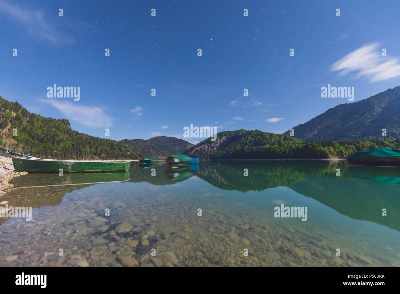 Germany, Bavaria, Sylvenstein Dam, boats at night, long exposure Stock Photo