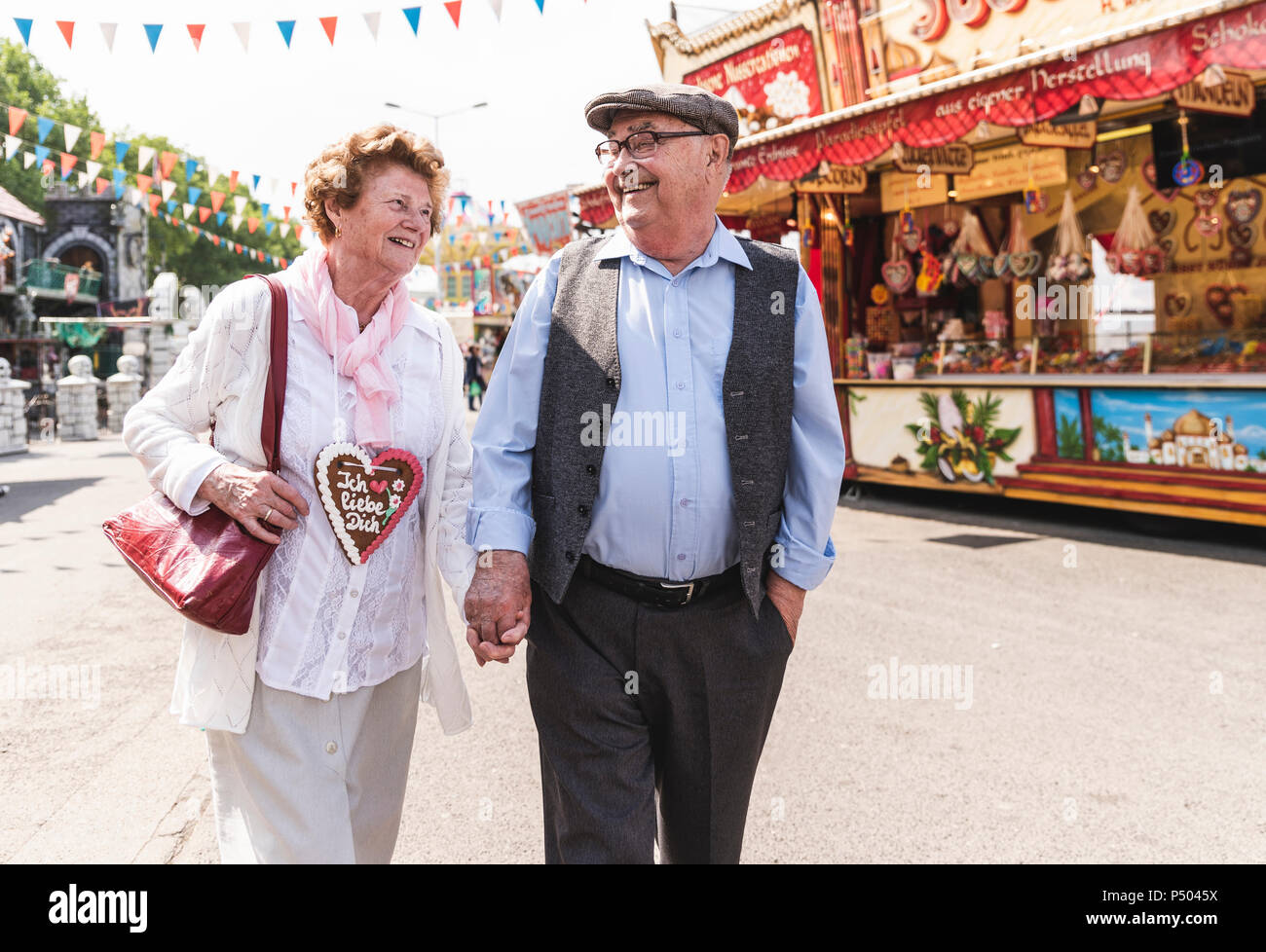 Old couple walking hand in hand hi-res stock photography and images - Alamy
