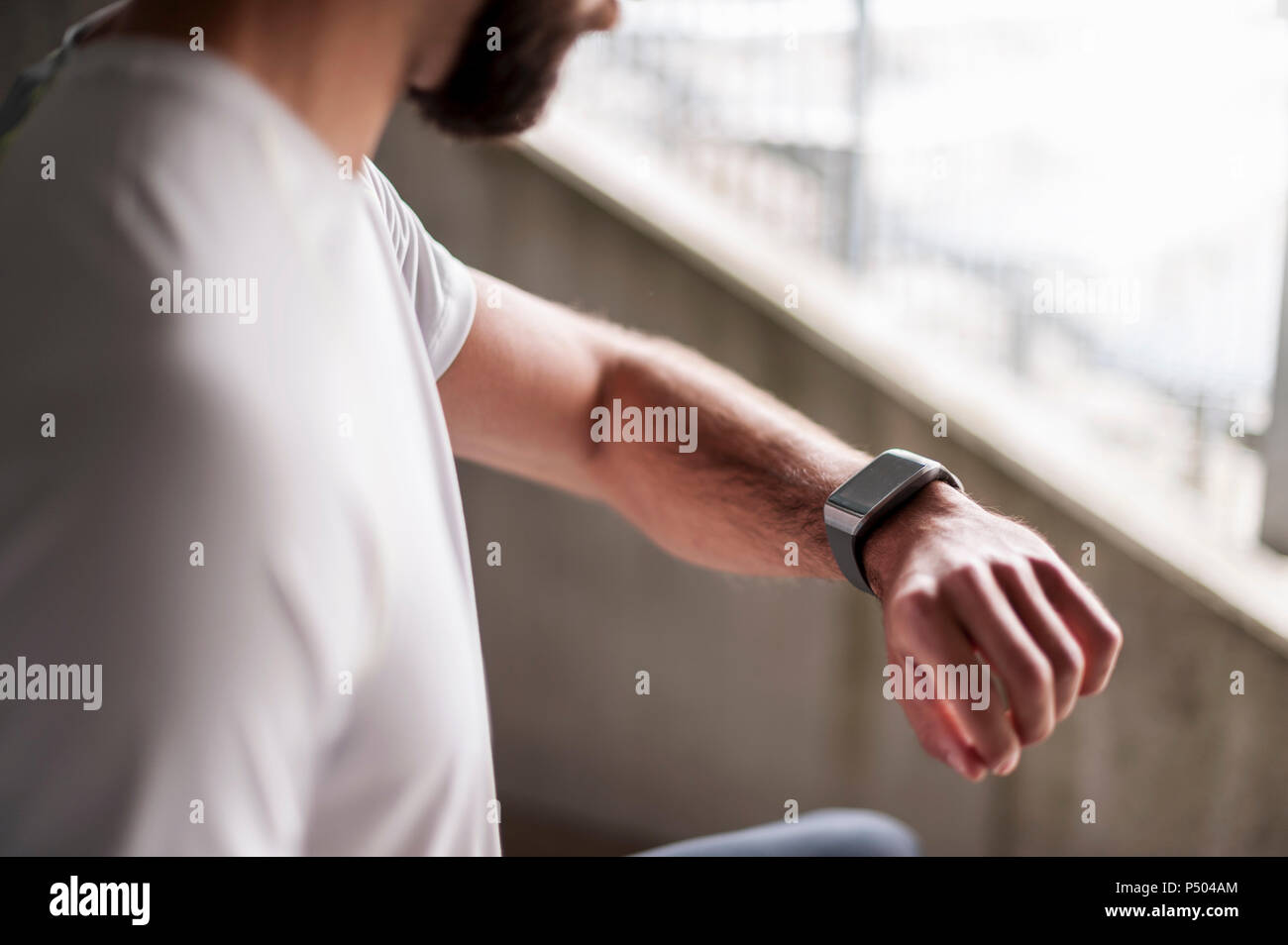 Athlete checking the time on a smartwatch Stock Photo